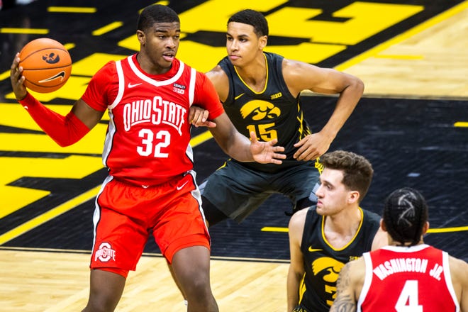 Ohio State forward E.J. Liddell (32) dribbles as Iowa forward Keegan Murray (15) defends during a NCAA Big Ten Conference men's basketball game, Thursday, Feb. 4, 2021, at Carver-Hawkeye Arena in Iowa City, Iowa.