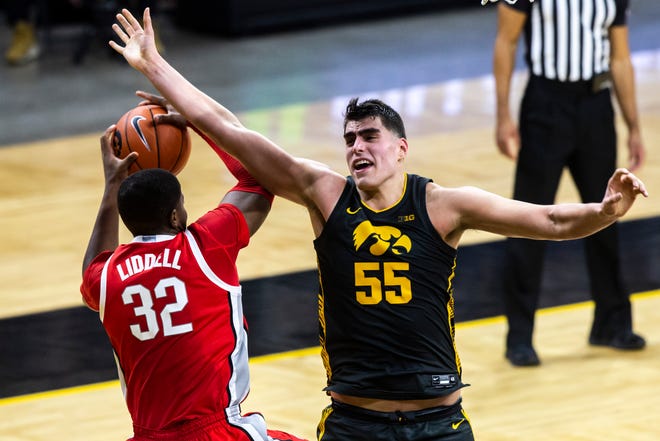 Ohio State forward E.J. Liddell (32) pulls down a rebound against Iowa center Luka Garza (55) during a NCAA Big Ten Conference men's basketball game, Thursday, Feb. 4, 2021, at Carver-Hawkeye Arena in Iowa City, Iowa.