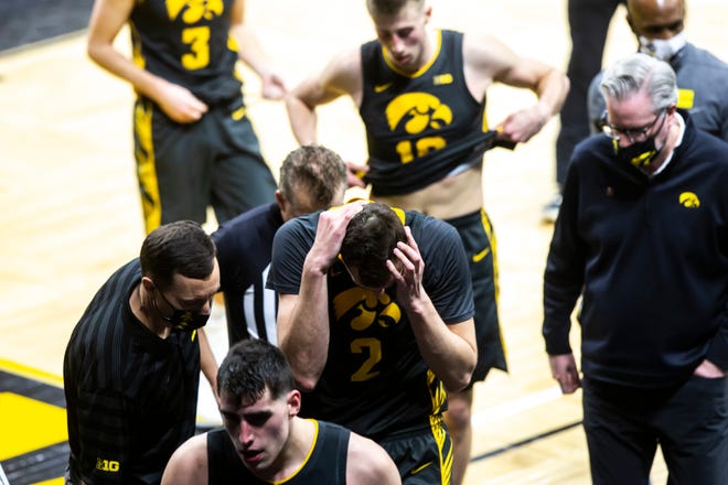 Iowa center Luka Garza, left, and forward Jack Nunge (2) walk off the court after losing to the Ohio State Buckeyes, 89-85, during a NCAA Big Ten Conference men's basketball game, Thursday, Feb. 4, 2021, at Carver-Hawkeye Arena in Iowa City, Iowa.