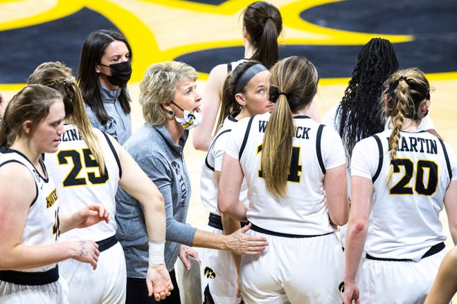 Iowa head coach Lisa Bluder talks with players in a timeout during a NCAA Big Ten Conference women's basketball game against Indiana, Sunday, Feb. 7, 2021, at Carver-Hawkeye Arena in Iowa City, Iowa.