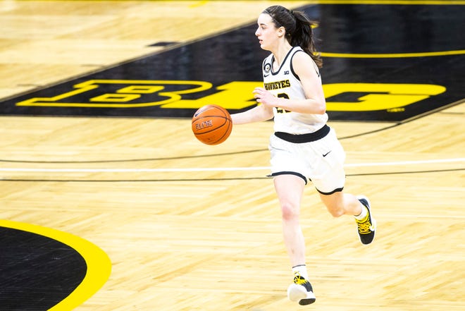 Iowa guard Caitlin Clark (22) takes the ball up court during a NCAA Big Ten Conference women's basketball game against Indiana, Sunday, Feb. 7, 2021, at Carver-Hawkeye Arena in Iowa City, Iowa.