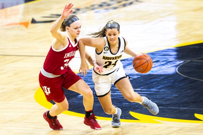 Iowa guard Gabbie Marshall (24) drives to the lane against Indiana guard Grace Berger, left, during a NCAA Big Ten Conference women's basketball game, Sunday, Feb. 7, 2021, at Carver-Hawkeye Arena in Iowa City, Iowa.