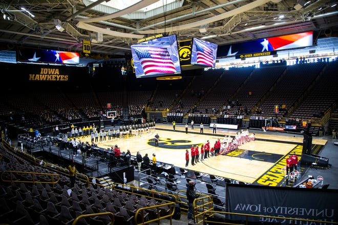 Members of the Indiana Hoosiers kneel as the national anthem is played before a NCAA Big Ten Conference women's basketball game against Iowa, Sunday, Feb. 7, 2021, at Carver-Hawkeye Arena in Iowa City, Iowa.