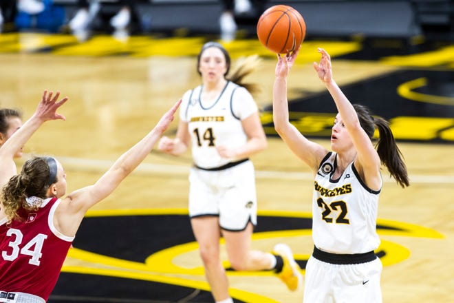 Iowa guard Caitlin Clark (22) makes a 3-point basket as Indiana guard Grace Berger (34) defends during a NCAA Big Ten Conference women's basketball game, Sunday, Feb. 7, 2021, at Carver-Hawkeye Arena in Iowa City, Iowa.