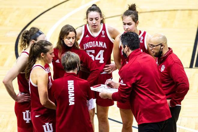 Indiana associate head coach Rhet Wierzb, second from right, draws up a play with Indiana head coach Teri Moren, center left, while talking with players in a timeout during a NCAA Big Ten Conference women's basketball game against Iowa, Sunday, Feb. 7, 2021, at Carver-Hawkeye Arena in Iowa City, Iowa.