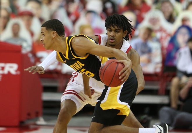 Feb 18, 2021; Madison, Wisconsin, USA; Iowa Hawkeyes forward Keegan Murray (left) takes the ball past Wisconsin Badgers forward Aleem Ford (2)  during the first half at the Kohl Center. Mandatory Credit: Mary Langenfeld-USA TODAY Sports