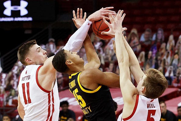 MADISON, WISCONSIN - FEBRUARY 18: Micah Potter #11 of the Wisconsin Badgers blocks a shot attempt by Keegan Murray #15 of the Iowa Hawkeyes as Tyler Wahl #5 of the Badgers defends in the first half at the Kohl Center on February 18, 2021 in Madison, Wisconsin. (Photo by Dylan Buell/Getty Images)