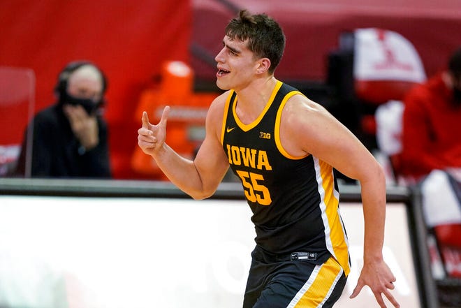 Iowa's Luka Garza celebrates a basket against Wisconsin during the first half of an NCAA college basketball game Thursday, Feb. 18, 2021, in Madison, Wis. (AP Photo/Andy Manis)