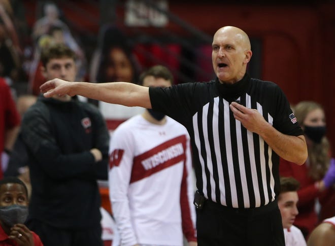 Feb 18, 2021; Madison, Wisconsin, USA; An NCAA referee motions to Iowa Hawkeyes head coach Fran McCaffery to get off the floor in the game against the Wisconsin Badgers during the second half at the Kohl Center. Mandatory Credit: Mary Langenfeld-USA TODAY Sports