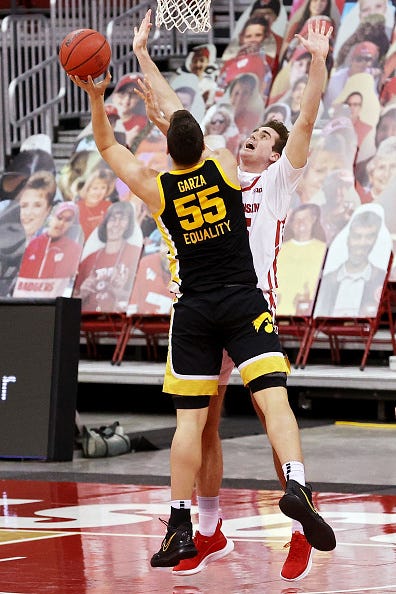 MADISON, WISCONSIN - FEBRUARY 18: Luka Garza #55 of the Iowa Hawkeyes attempts a shot while being guarded by Nate Reuvers #35 of the Wisconsin Badgers in the first half at the Kohl Center on February 18, 2021 in Madison, Wisconsin. (Photo by Dylan Buell/Getty Images)