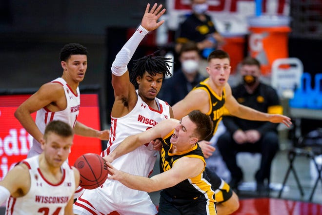 Iowa's Connor McCaffery (30) battles against Wisconsin's Aleem Ford (2) during the second half of an NCAA college basketball game Thursday, Feb. 18, 2021, in Madison, Wis. (AP Photo/Andy Manis)