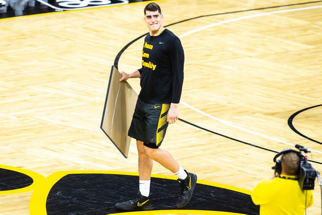 Iowa center Luka Garza smiles while carrying a framed jersey on senior day before a NCAA Big Ten Conference men's basketball game against Wisconsin, Sunday, March 7, 2021, at Carver-Hawkeye Arena in Iowa City, Iowa.