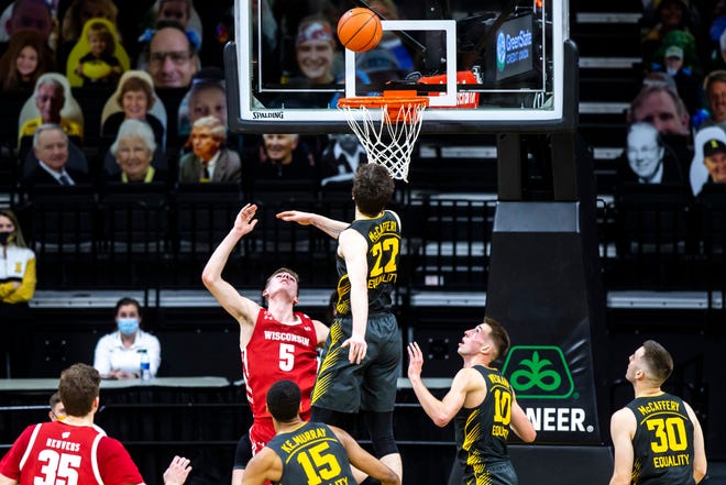 Wisconsin forward Tyler Wahl (5) makes a basket as Iowa forward Patrick McCaffery (22) defends during a NCAA Big Ten Conference men's basketball game, Sunday, March 7, 2021, at Carver-Hawkeye Arena in Iowa City, Iowa.