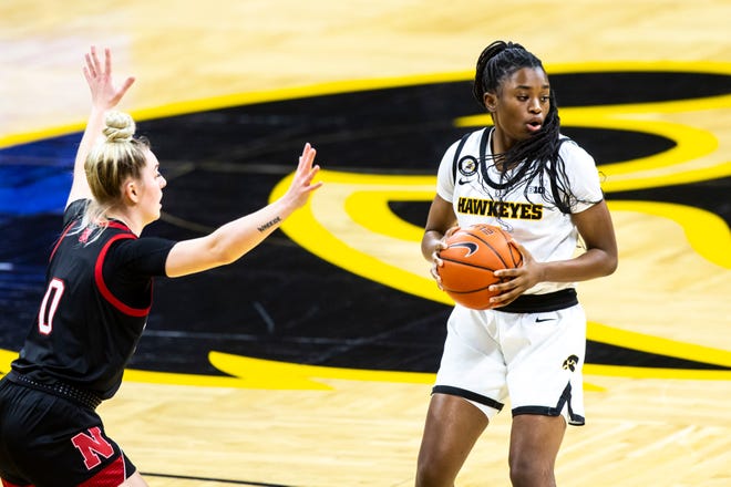 Iowa guard Tomi Taiwo looks to pass as Nebraska guard 	Ashley Scoggin (0) defends during a NCAA Big Ten Conference women's basketball game, Saturday, March 6, 2021, at Carver-Hawkeye Arena in Iowa City, Iowa.