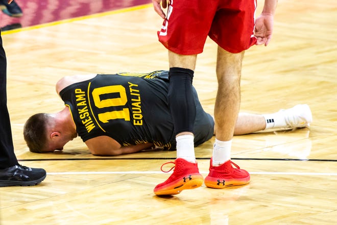 Iowa's Joe Wieskamp (10) falls to the ground during a NCAA Big Ten Conference men's basketball game against Wisconsin, Sunday, March 7, 2021, at Carver-Hawkeye Arena in Iowa City, Iowa.