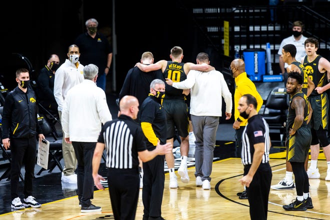 Iowa's Joe Wieskamp (10) gets helped off the court during a NCAA Big Ten Conference men's basketball game against Wisconsin, Sunday, March 7, 2021, at Carver-Hawkeye Arena in Iowa City, Iowa.