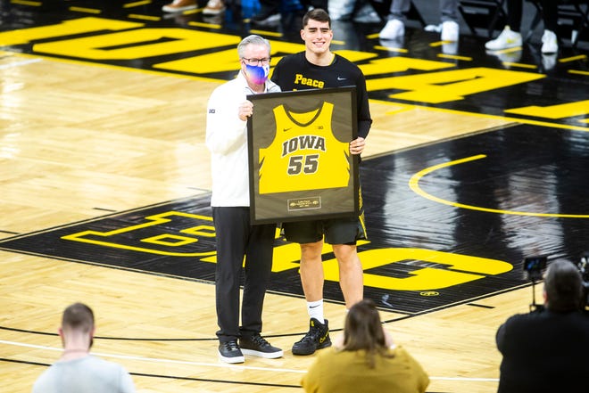 Iowa center Luka Garza (55) poses for a photo with Iowa head coach Fran McCaffery on senior day before a NCAA Big Ten Conference men's basketball game against Wisconsin, Sunday, March 7, 2021, at Carver-Hawkeye Arena in Iowa City, Iowa.