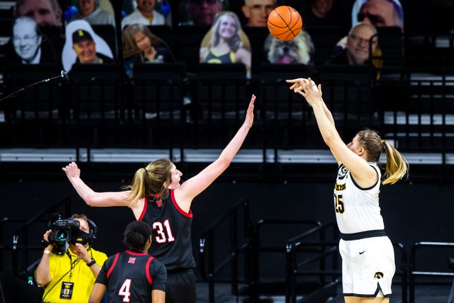 Iowa center Monika Czinano (25) makes a basket as Nebraska center Kate Cain (31) defends during a NCAA Big Ten Conference women's basketball game, Saturday, March 6, 2021, at Carver-Hawkeye Arena in Iowa City, Iowa.