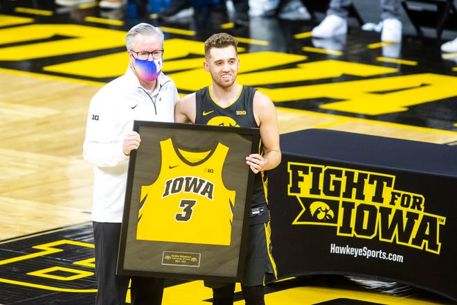 Iowa guard Jordan Bohannon poses for a photo with Iowa head coach Fran McCaffery on senior day before a NCAA Big Ten Conference men's basketball game against Wisconsin, Sunday, March 7, 2021, at Carver-Hawkeye Arena in Iowa City, Iowa.