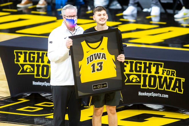 Iowa head coach Fran McCaffery poses for a photo with Iowa guard Austin Ash (13) on senior day before a NCAA Big Ten Conference men's basketball game against Wisconsin, Sunday, March 7, 2021, at Carver-Hawkeye Arena in Iowa City, Iowa.