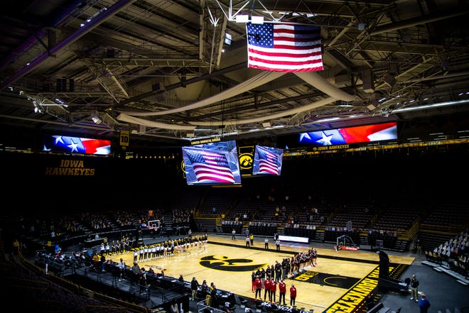 A general view as Nebraska Cornhuskers and Iowa Hawkeyes players stand as the national anthem is played before a NCAA Big Ten Conference women's basketball game, Saturday, March 6, 2021, at Carver-Hawkeye Arena in Iowa City, Iowa.