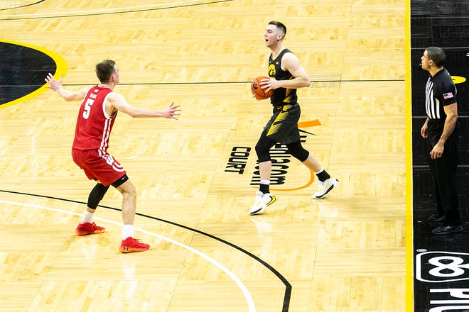 Iowa's Connor McCaffery (30) looks to pass as Wisconsin forward Tyler Wahl (5) defends during a NCAA Big Ten Conference men's basketball game, Sunday, March 7, 2021, at Carver-Hawkeye Arena in Iowa City, Iowa.