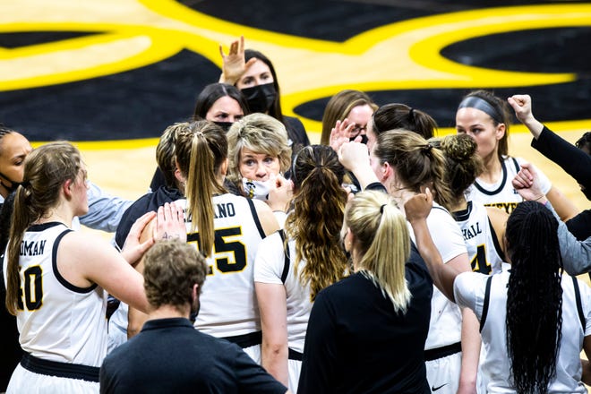 Iowa head coach Lisa Bluder huddles up with players in a timeout during a NCAA Big Ten Conference women's basketball game against Nebraska, Saturday, March 6, 2021, at Carver-Hawkeye Arena in Iowa City, Iowa.