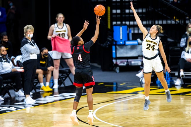 Nebraska guard Sam Haiby (4) makes a 3-point basket as Iowa guard Gabbie Marshall (24) defends during a NCAA Big Ten Conference women's basketball game, Saturday, March 6, 2021, at Carver-Hawkeye Arena in Iowa City, Iowa.