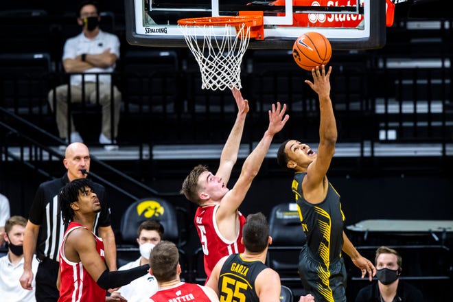 Iowa forward Keegan Murray (15) makes a basket as Wisconsin forward Tyler Wahl (5) defends during a NCAA Big Ten Conference men's basketball game, Sunday, March 7, 2021, at Carver-Hawkeye Arena in Iowa City, Iowa.
