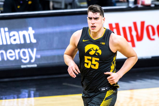 Iowa center Luka Garza (55) reacts after making a basket during a NCAA Big Ten Conference men's basketball game against Wisconsin, Sunday, March 7, 2021, at Carver-Hawkeye Arena in Iowa City, Iowa.