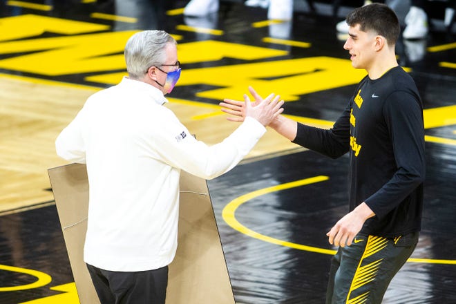 Iowa center Luka Garza, right, goes in for a hug with Iowa head coach Fran McCaffery on senior day before a NCAA Big Ten Conference men's basketball game against Wisconsin, Sunday, March 7, 2021, at Carver-Hawkeye Arena in Iowa City, Iowa.