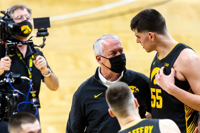Iowa athletic director Gary Barta talks with Iowa center Luka Garza (55) after a NCAA Big Ten Conference men's basketball game against Wisconsin, Sunday, March 7, 2021, at Carver-Hawkeye Arena in Iowa City, Iowa.