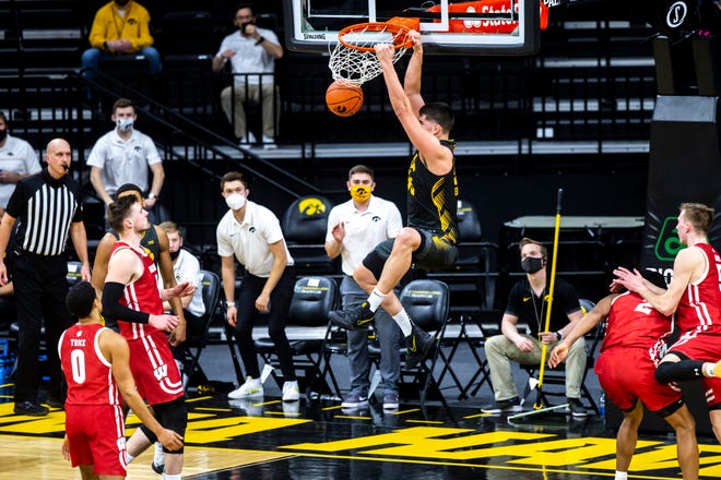 Iowa center Luka Garza (55) dunks the ball during a NCAA Big Ten Conference men's basketball game against Wisconsin, Sunday, March 7, 2021, at Carver-Hawkeye Arena in Iowa City, Iowa.
