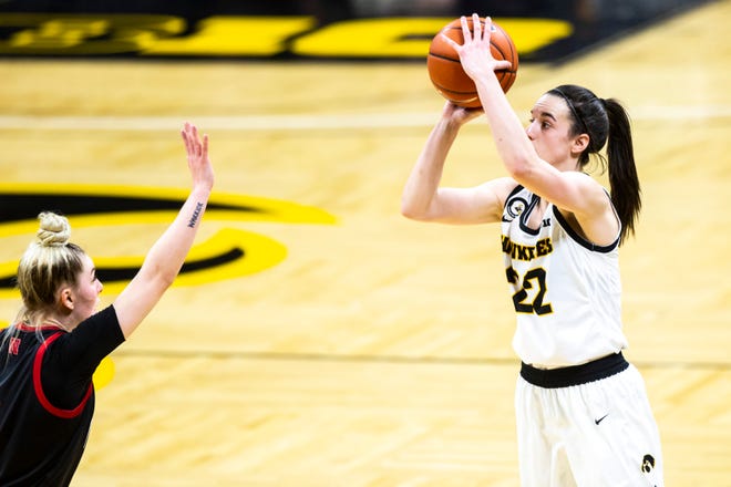 Iowa guard Caitlin Clark (22) makes a 3-point basket as Nebraska guard Ashley Scoggin defends during a NCAA Big Ten Conference women's basketball game, Saturday, March 6, 2021, at Carver-Hawkeye Arena in Iowa City, Iowa.