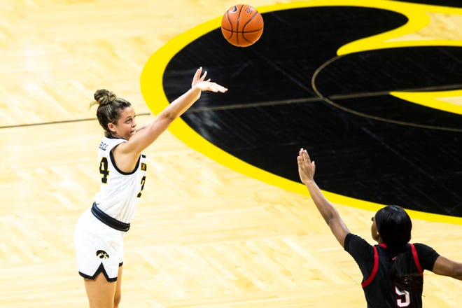 Iowa guard Gabbie Marshall, left, makes a 3-point basket as Nebraska guard MiCole Cayton defends during a NCAA Big Ten Conference women's basketball game, Saturday, March 6, 2021, at Carver-Hawkeye Arena in Iowa City, Iowa.