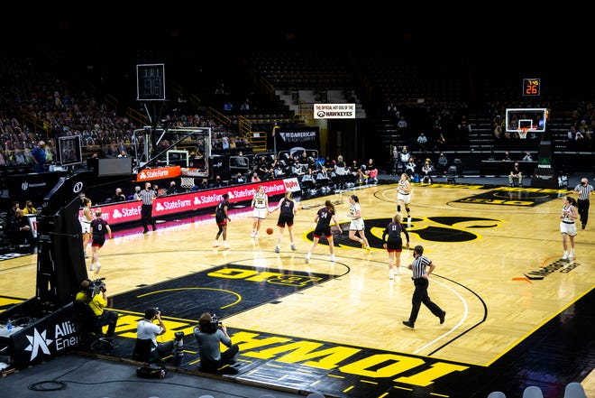 A general view as Iowa guard Kate Martin (20) takes the ball up court during a NCAA Big Ten Conference women's basketball game against Nebraska, Saturday, March 6, 2021, at Carver-Hawkeye Arena in Iowa City, Iowa. The south goal's shot clock was damaged prior to tipoff and a temporary one was placed on the west baseline.