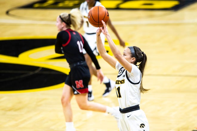 Iowa guard Megan Meyer (11) makes a 3-point basket during a NCAA Big Ten Conference women's basketball game against Nebraska, Saturday, March 6, 2021, at Carver-Hawkeye Arena in Iowa City, Iowa.