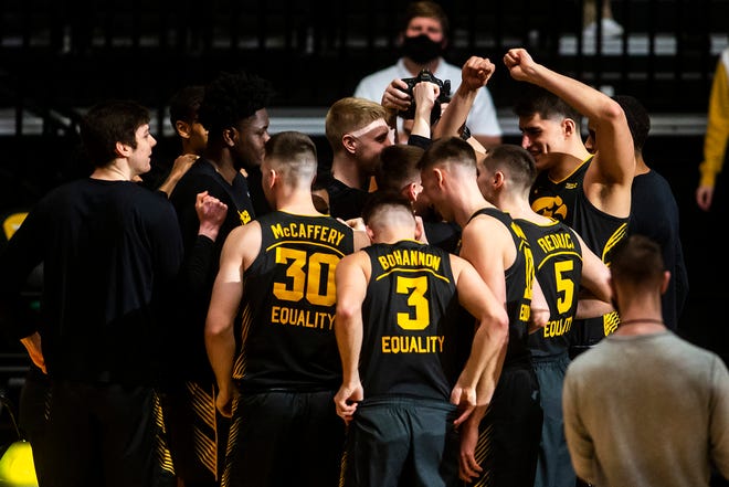 Iowa center Luka Garza, far right, huddles up with teammates before a NCAA Big Ten Conference men's basketball game against Wisconsin, Sunday, March 7, 2021, at Carver-Hawkeye Arena in Iowa City, Iowa.