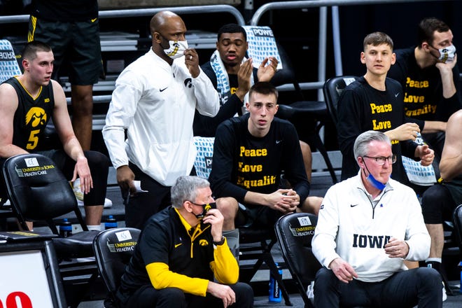 Iowa's Joe Wieskamp sits on the bench with a walking boot after being injured during a NCAA Big Ten Conference men's basketball game against Wisconsin, Sunday, March 7, 2021, at Carver-Hawkeye Arena in Iowa City, Iowa.
