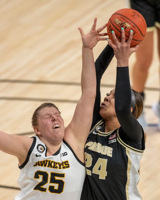 Iowa Hawkeyes forward Monika Czinano (25) defends Purdue Boilermakers center Ra Shaya Kyle (24) on Wednesday, March 10, 2021, during the women's Big Ten basketball tournament from Bankers Life Fieldhouse in Indianapolis. Iowa won 83-72.