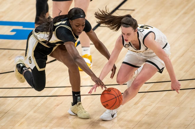 Purdue Boilermakers guard Tamara Farquhar (25) and Iowa Hawkeyes guard Caitlin Clark (22) look for possession on Wednesday, March 10, 2021, during the women's Big Ten basketball tournament from Bankers Life Fieldhouse in Indianapolis. Iowa won 83-72.