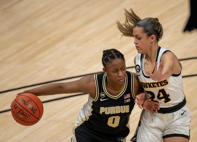 Purdue Boilermakers guard Brooke Moore (0) works against Iowa Hawkeyes guard Gabbie Marshall (24) on Wednesday, March 10, 2021, during the women's Big Ten basketball tournament from Bankers Life Fieldhouse in Indianapolis. Iowa won 83-72.