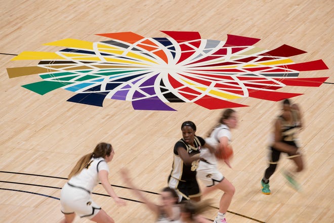 Players from Iowa and Purdue work near center court on Wednesday, March 10, 2021, during the women's Big Ten basketball tournament from Bankers Life Fieldhouse in Indianapolis. Iowa won 83-72.