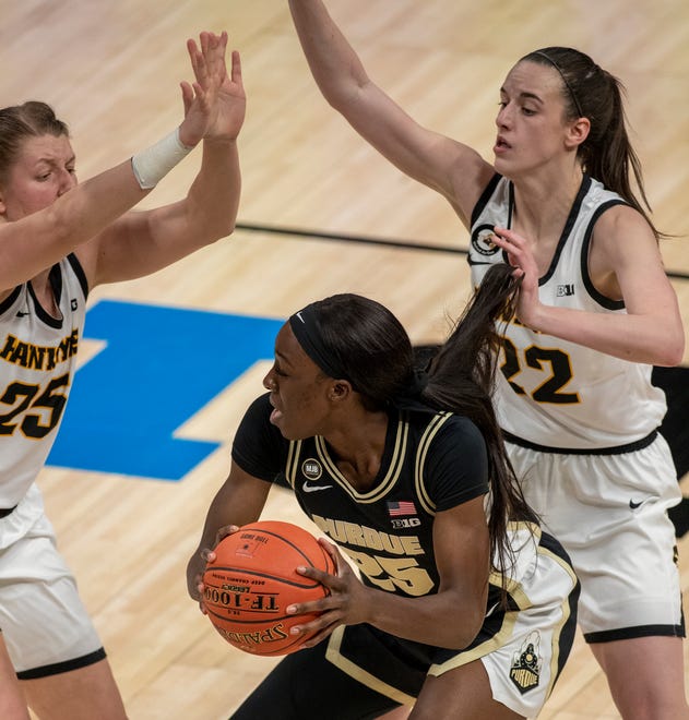 Purdue Boilermakers guard Tamara Farquhar (25) is well-defended by Iowa Hawkeyes forward Monika Czinano (25) and Caitlin Clark (22) on Wednesday, March 10, 2021, during the women's Big Ten basketball tournament from Bankers Life Fieldhouse in Indianapolis. Iowa won 83-72.