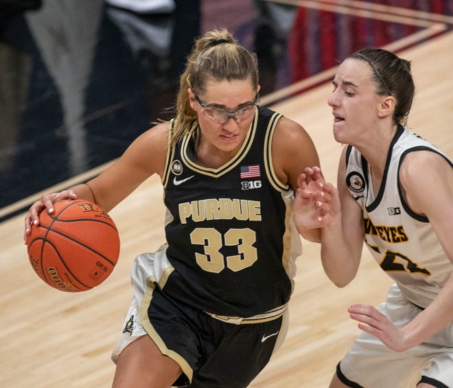 Purdue Boilermakers guard Madison Layden (33) works against Iowa Hawkeyes guard Caitlin Clark (22) on Wednesday, March 10, 2021, during the women's Big Ten basketball tournament from Bankers Life Fieldhouse in Indianapolis. Iowa won 83-72.