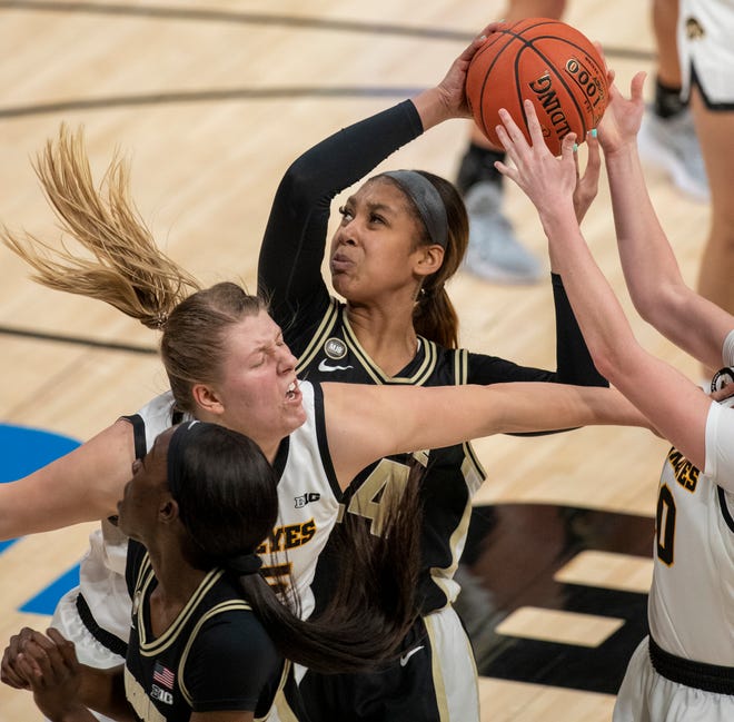 In a scrum, Purdue Boilermakers center Ra Shaya Kyle (24) looks for a shot under the basket on Wednesday, March 10, 2021, during the women's Big Ten basketball tournament from Bankers Life Fieldhouse in Indianapolis. Iowa won 83-72.