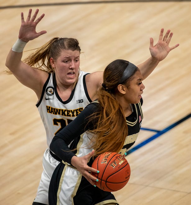 Iowa Hawkeyes forward Monika Czinano (25) defends Purdue Boilermakers center Ra Shaya Kyle (24) on Wednesday, March 10, 2021, during the women's Big Ten basketball tournament from Bankers Life Fieldhouse in Indianapolis. Iowa won 83-72.