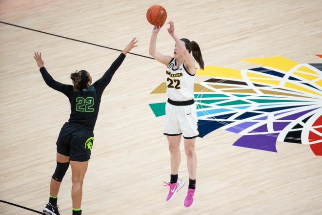 Mar 12, 2021; Indianapolis, IN, USA; Iowa Hawkeyes guard Caitlin Clark (22) shoots the ball over Michigan State Spartans guard Moira Joiner (22) in the third quarter at Bankers Life Fieldhouse.