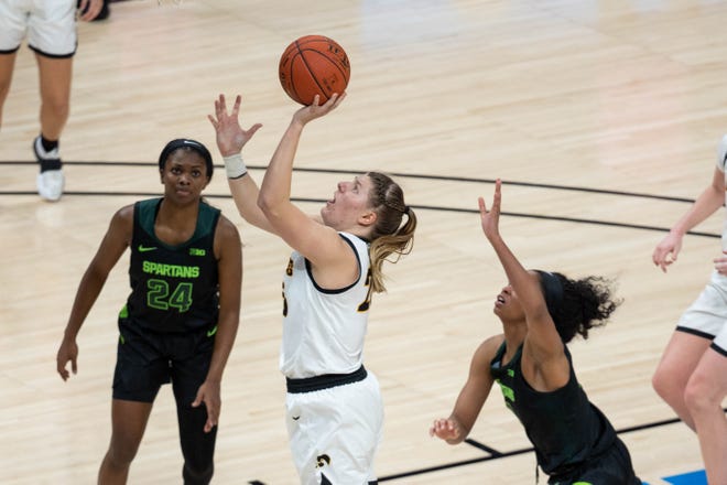 Mar 12, 2021; Indianapolis, IN, USA; Iowa Hawkeyes forward Monika Czinano (25) shoots the ball while Michigan State Spartans forward Alisia Smith (4) defends  in the fourth quarter at Bankers Life Fieldhouse. Mandatory Credit: Trevor Ruszkowski-USA TODAY Sports