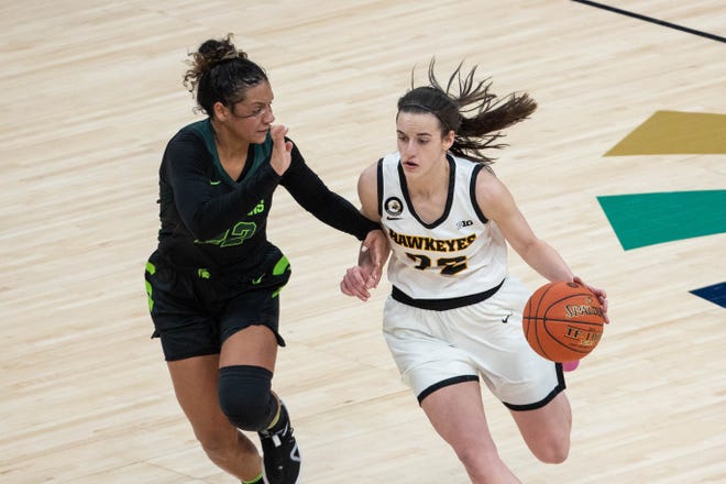 Mar 12, 2021; Indianapolis, IN, USA; Iowa Hawkeyes guard Caitlin Clark (22) dribbles the ball while Michigan State Spartans guard Moira Joiner (22) defends  in the fourth quarter at Bankers Life Fieldhouse. Mandatory Credit: Trevor Ruszkowski-USA TODAY Sports